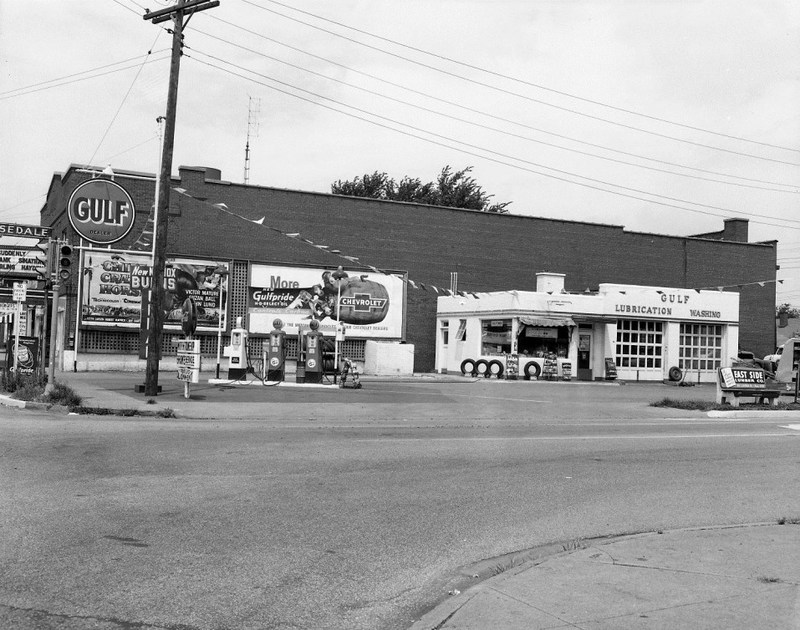 Vintage black and white photo of a Gulf gas station with service signs.