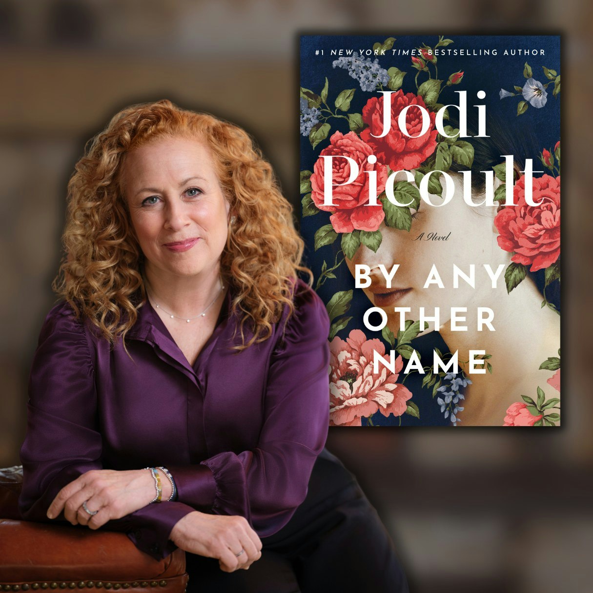 A person seated beside a book cover titled "By Any Other Name" by Jodi Picoult, featuring floral artwork.