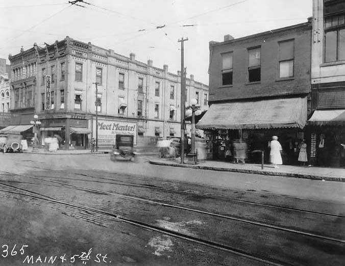 May contain: city, road, street, urban, neighborhood, and person