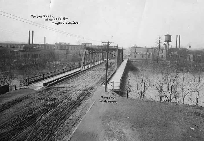 Historic photo of Pigeon Creek, railroad tracks, and industrial buildings in Evansville, Indiana.