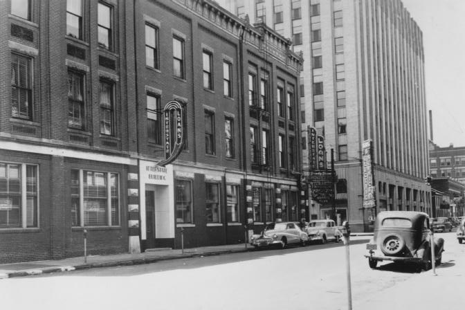 Vintage street corner with old cars and buildings.