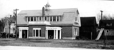 Old fire station building with a sliding pole visible on the side.