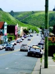 View of downtown Point Arena street with green hills