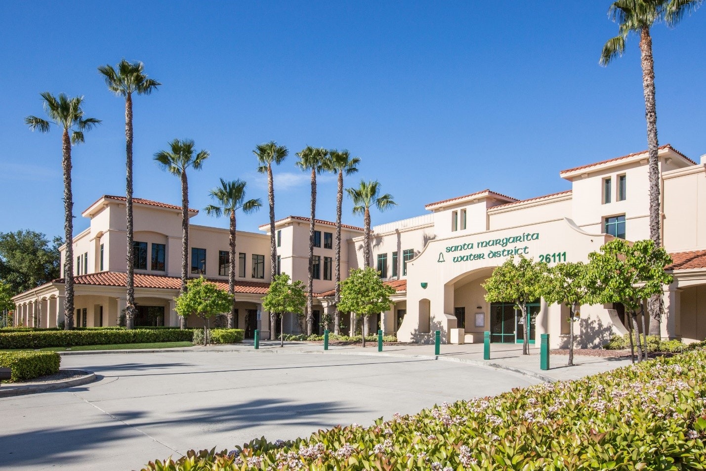 A building with palm trees and signage for the Santa Margarita Water District, featuring a sunny, clear sky.