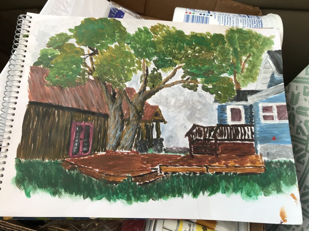 A painting of a backyard scene with trees, a wooden deck, and houses in the background, on a spiral sketchbook.