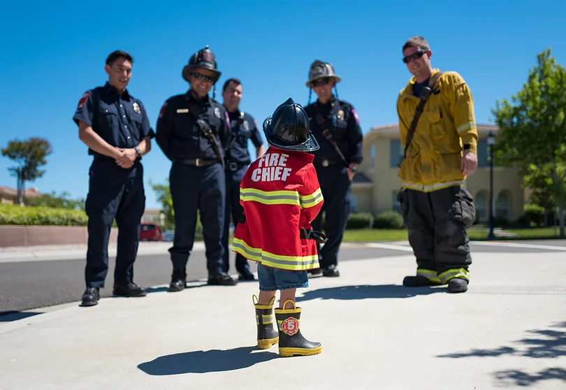 may contain: Firefighters, people. trees, child
