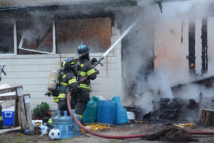 May contain: extinguishing fire, fire, person, ball, football, soccer, soccer ball, and sport