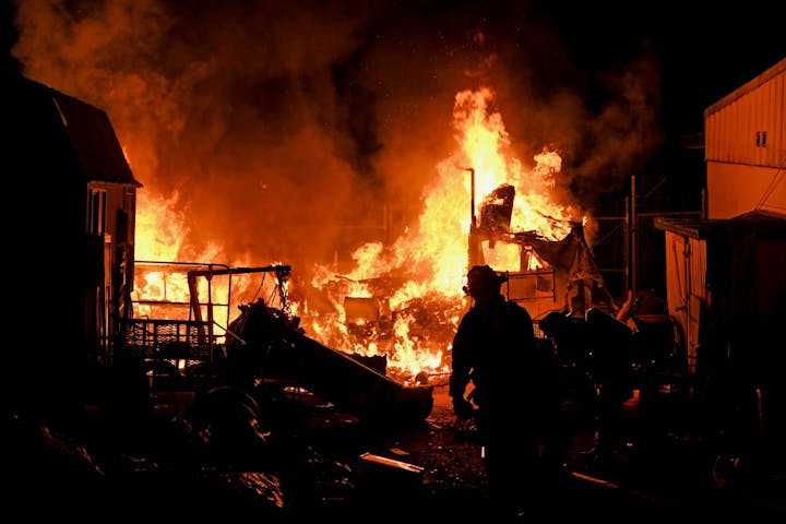 May contain: clothing, glove, adult, male, man, person, fire, and flame
