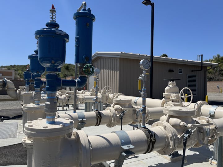 Industrial piping and valves with pressure gauges, possibly part of a gas or water distribution system.