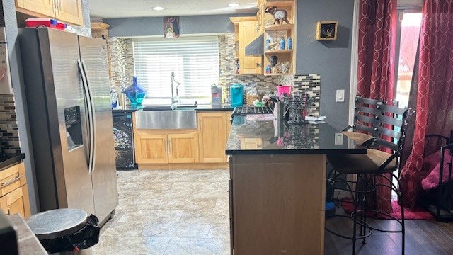 A modern kitchen with wooden cabinets, stainless steel appliances, a large sink, decorative items, and a dining area with chairs.
