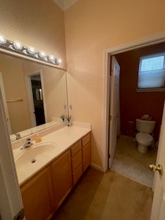 The image shows a bathroom with a sink, mirror, and tub, along with a toilet in a separate space, all in a light, neutral color scheme.