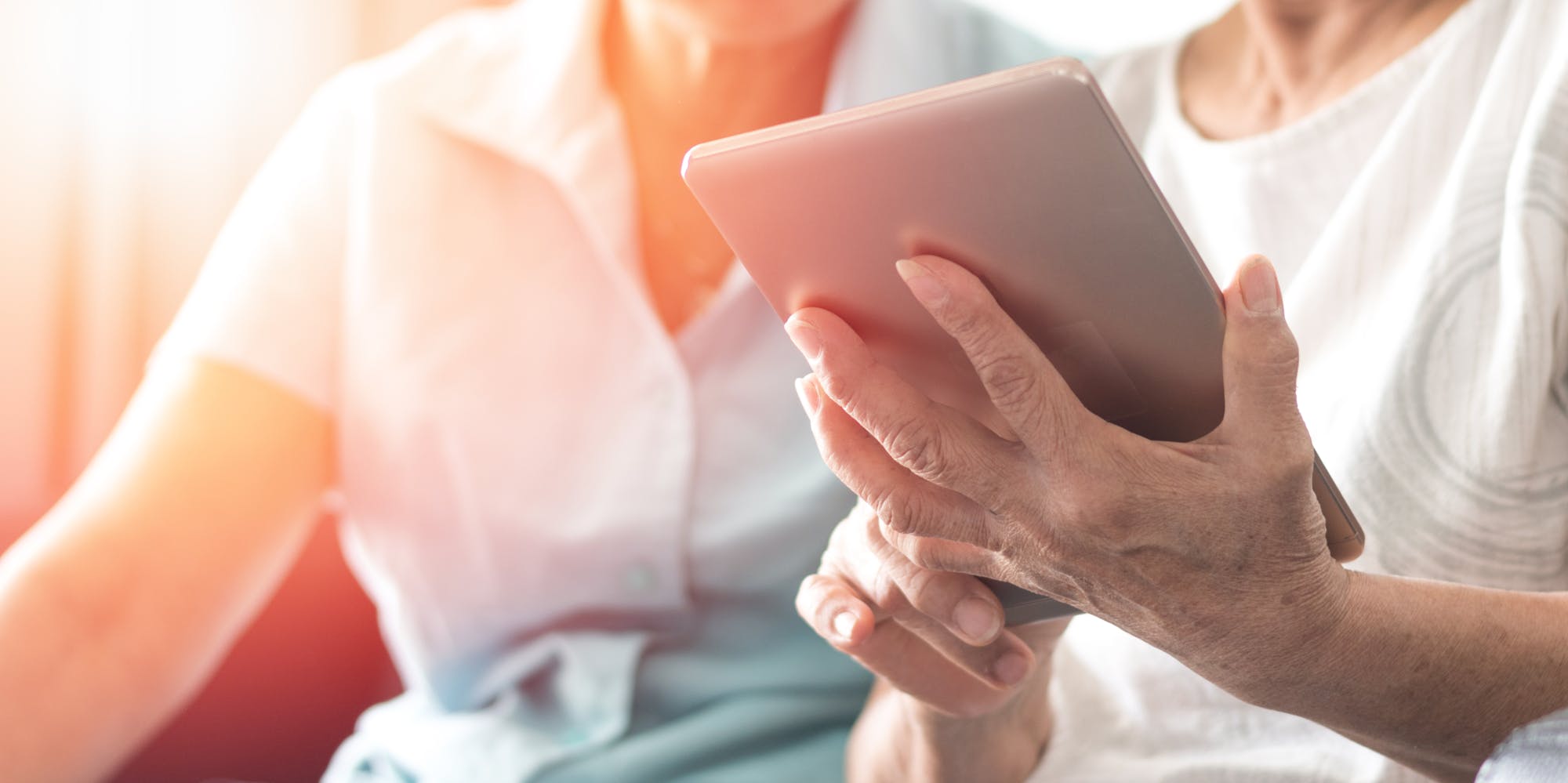 Two people using a tablet.