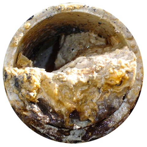 A clogged pipe filled with a thick, greasy substance blocking the flow.
