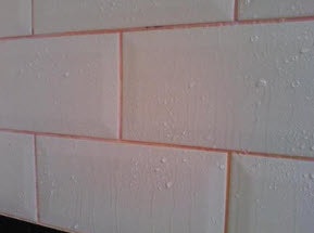 White tiles with water droplets on them.