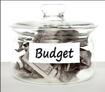 Glass jar with paper money and label "budget"