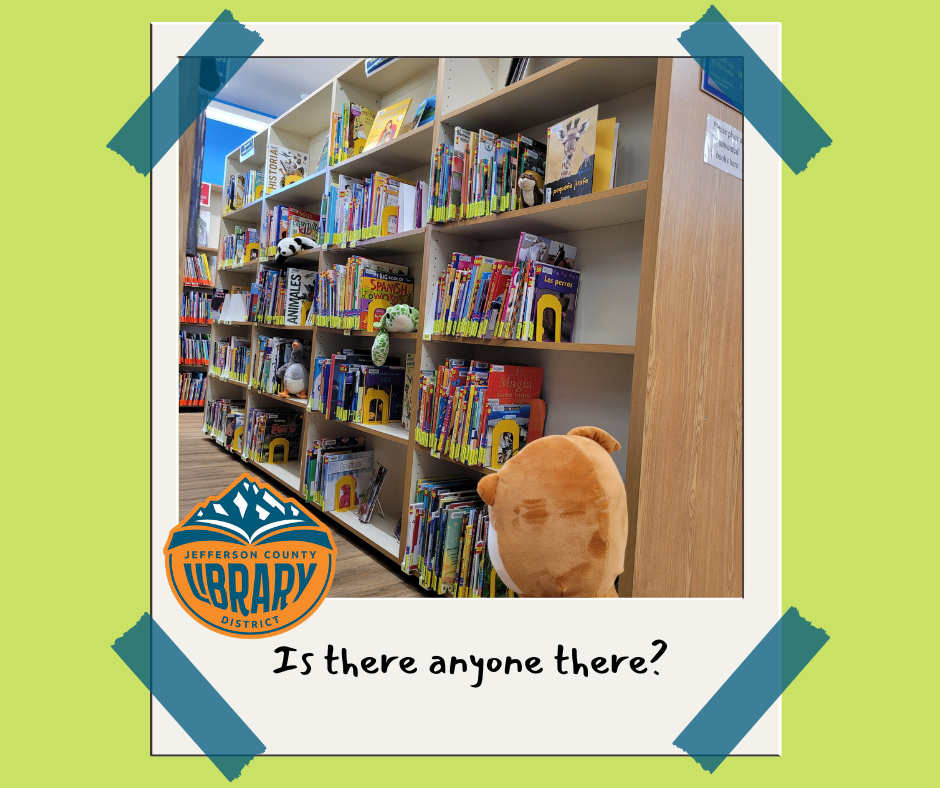 Stuffed animals and books on bookshelves.