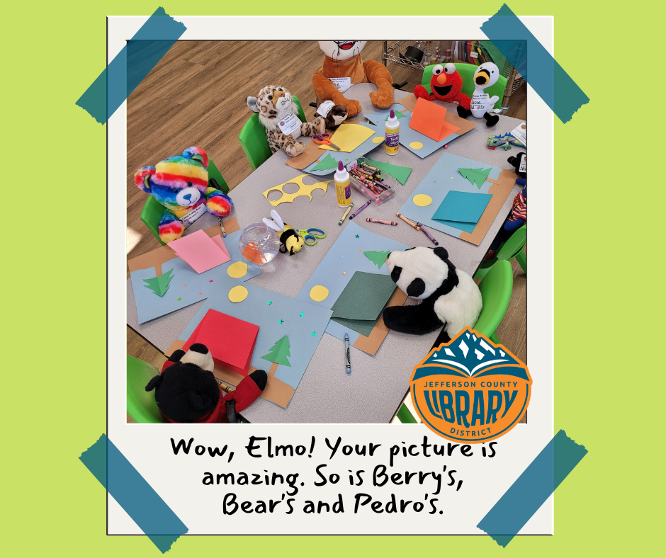 Stuffed animals around a table with art supplies.