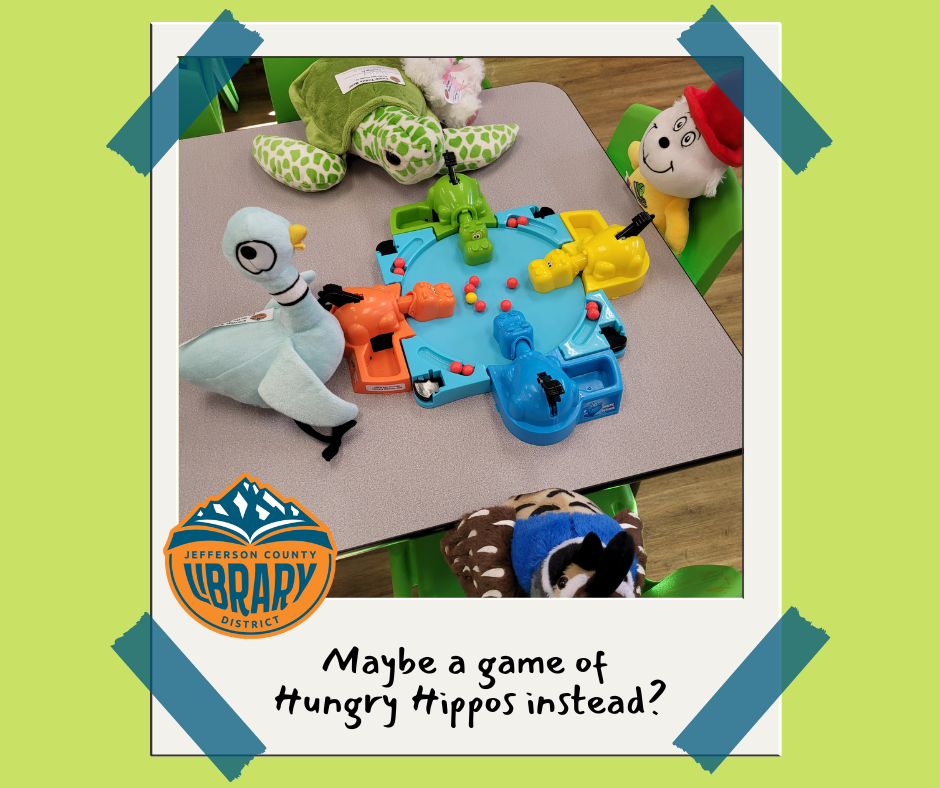 Stuffed animals around a table with art supplies.