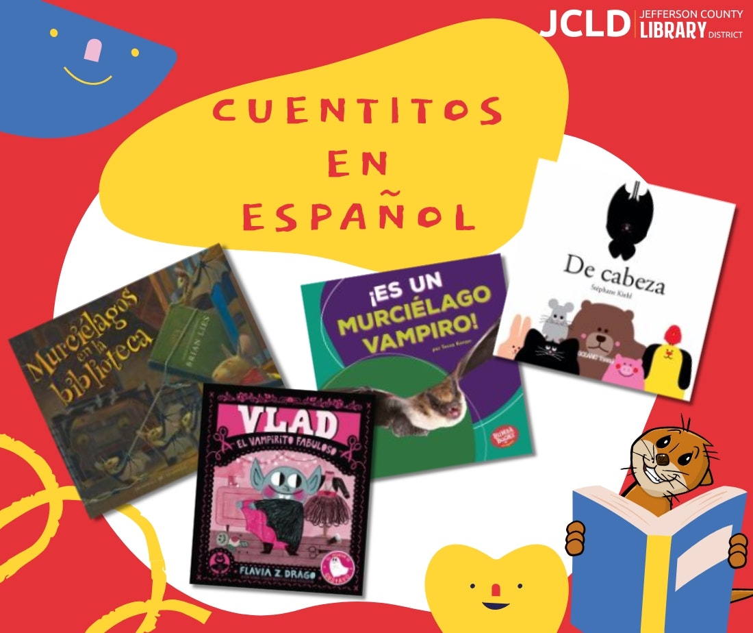 Children's Spanish book display with colorful covers and an otter reading a book illustration.