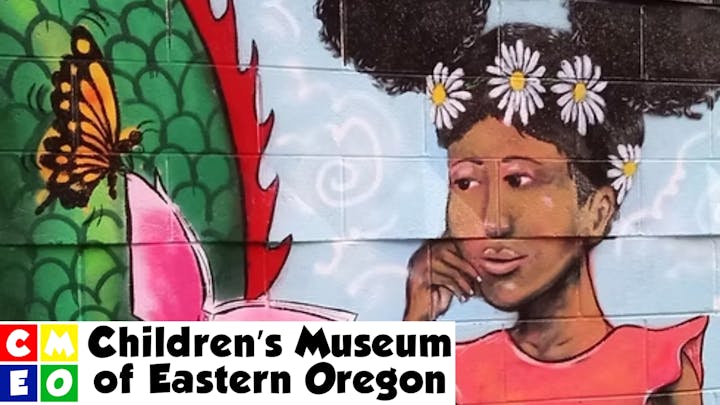 A mural of a girl with daisies in her hair looking at a butterfly. Text: "Children's Museum of Eastern Oregon."