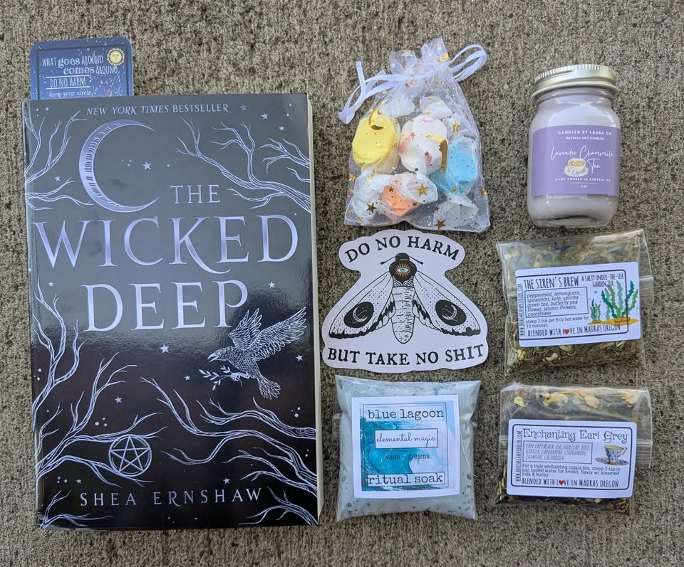 "The Wicked Deep" book, teas, candle, ritual soak, candy pouch, and a sticker with "Do No Harm But Take No Shit".