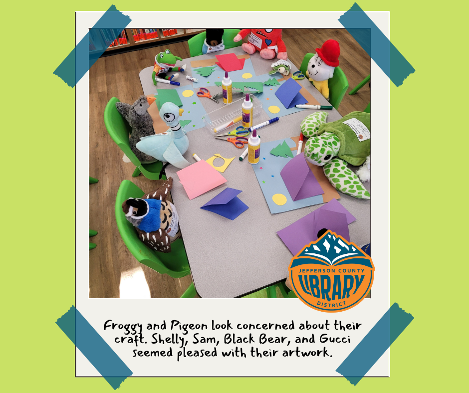 Stuffed animals around a table with art supplies.