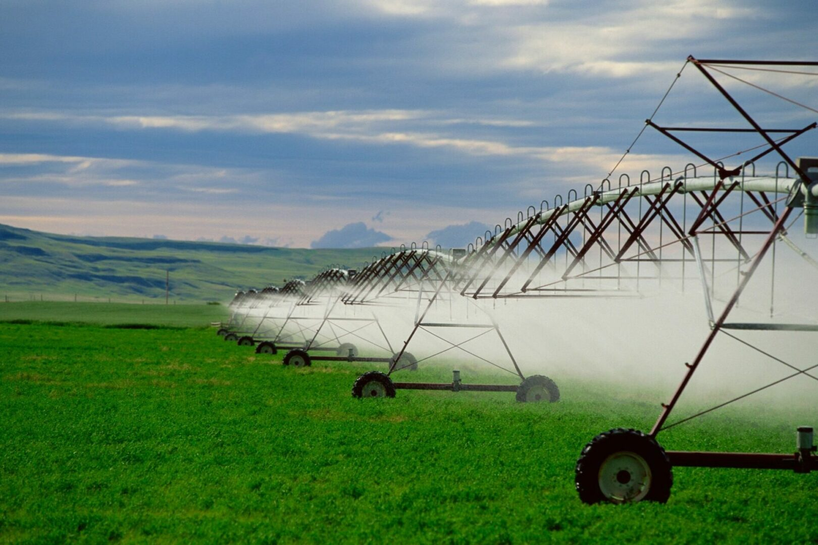May contain: grass, plant, field, grassland, nature, outdoors, landscape, agriculture, countryside, lawn, scenery, green, sky, farm, pasture, rural, machine, wheel, and land