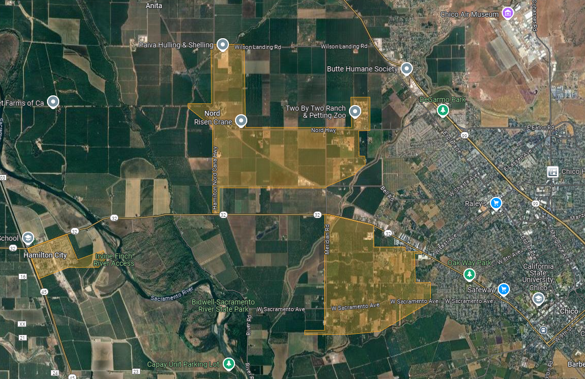 A satellite map showing agricultural fields, a river, and sections of Chico, California, with labels of local landmarks and roads.
