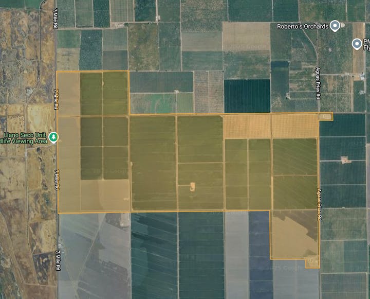 Aerial view of agricultural fields, with roads and points of interest labeled, including a wildlife viewing area and orchards.