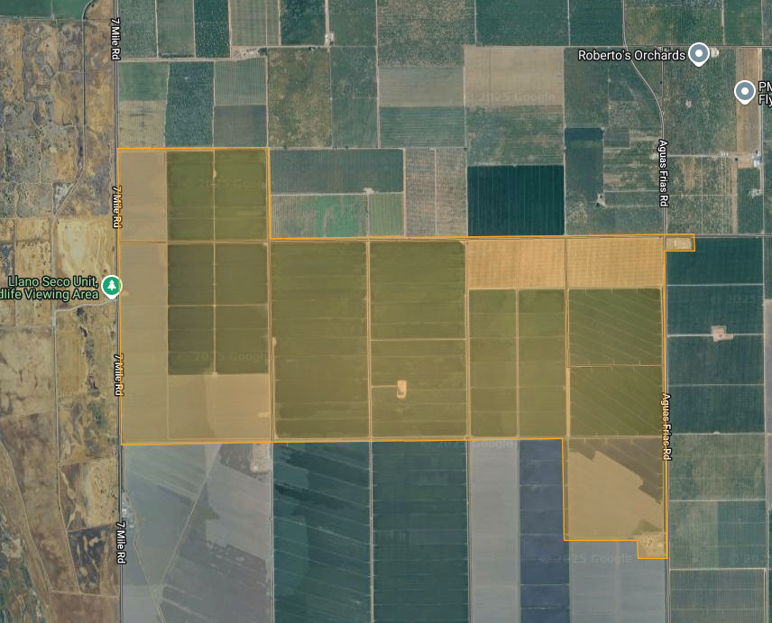 Aerial view of agricultural fields, with roads and points of interest labeled, including a wildlife viewing area and orchards.