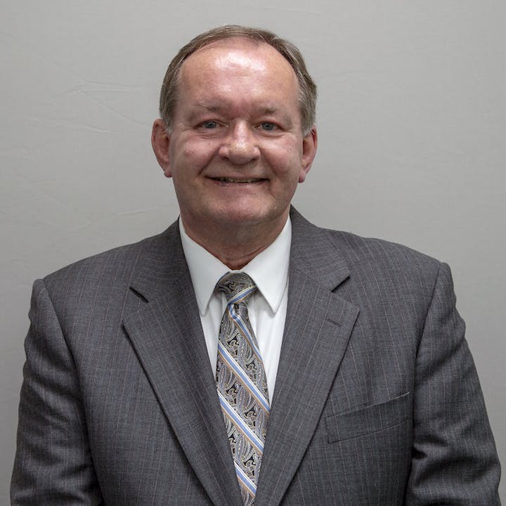 headshot of Thomas Howard in suit and tie