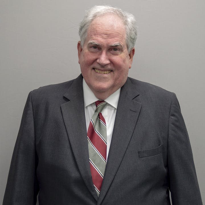 headshot of William Broome in suit and tie