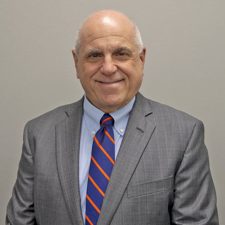 headshot of George Gentile in suit and tie
