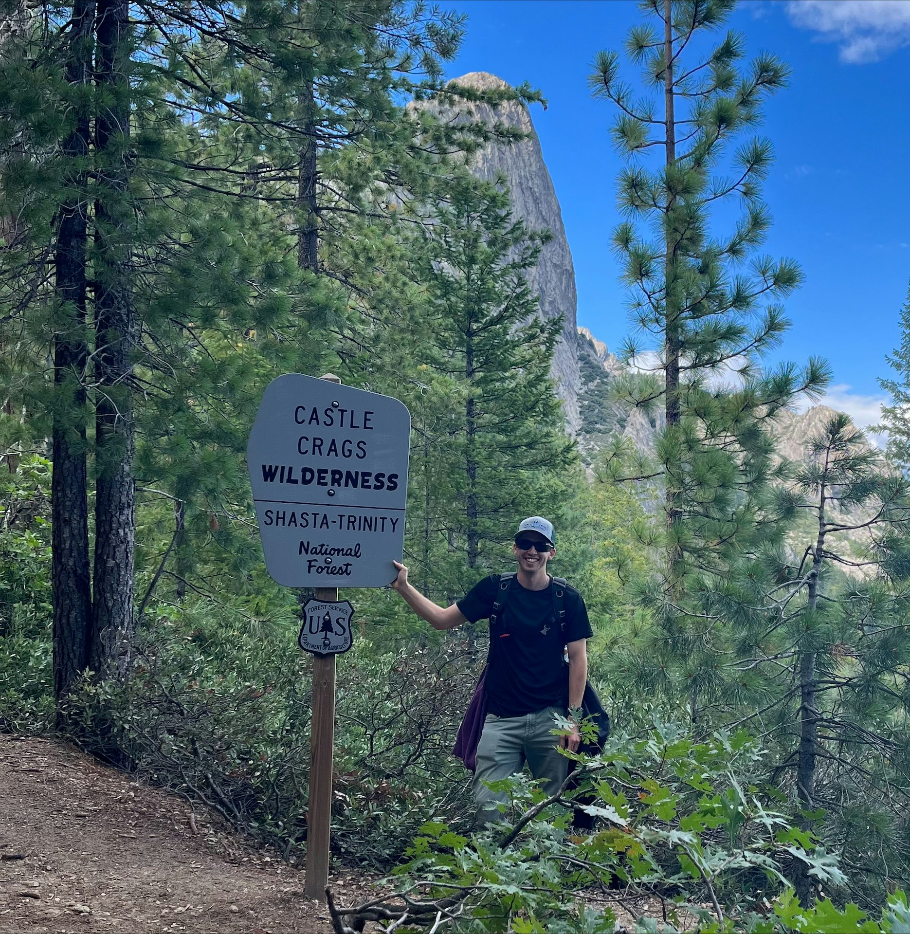 May contain: nature, outdoors, wilderness, adventure, hiking, leisure activities, person, plant, tree, vegetation, path, land, woodland, grove, conifer, jungle, face, head, photography, portrait, trail, clothing, hat, and rock