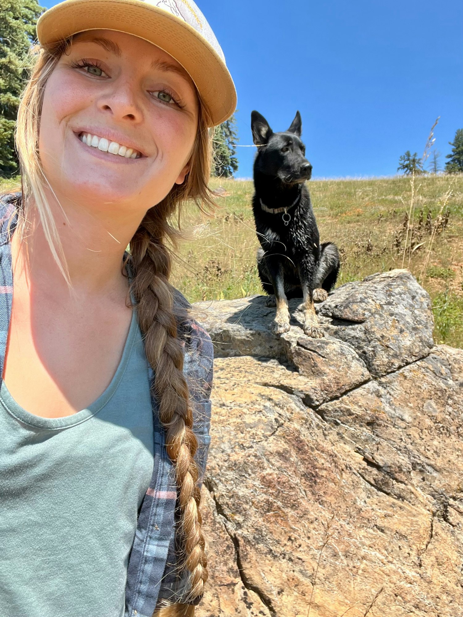 May contain: rock, braid, hair, person, animal, canine, dog, mammal, pet, face, head, photography, portrait, clothing, hat, and outdoors