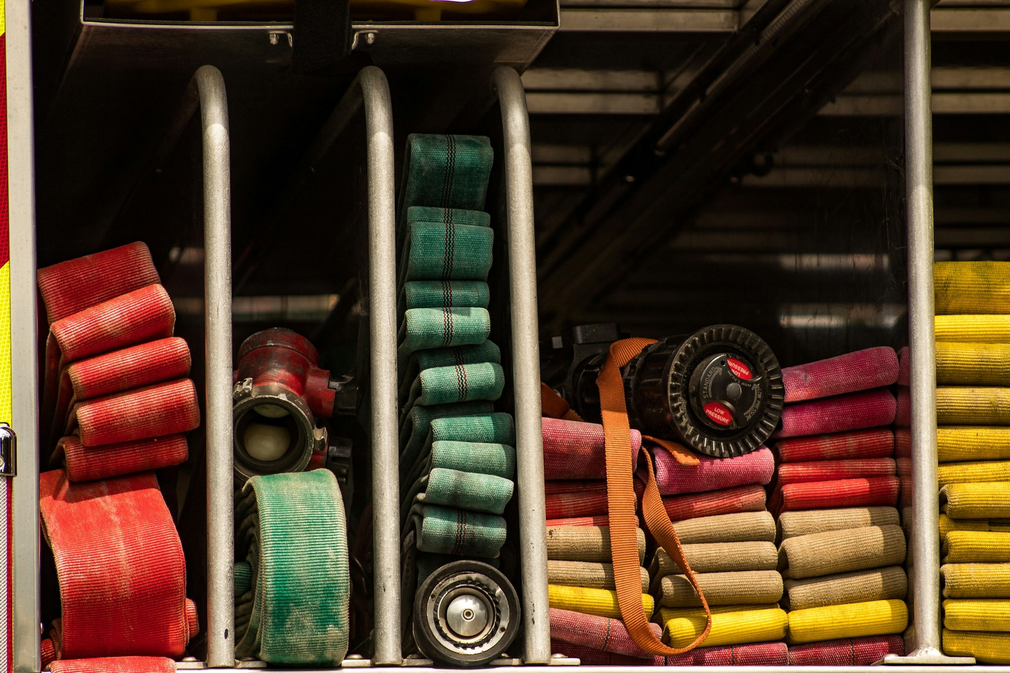 stacks of fire hoses in different colors