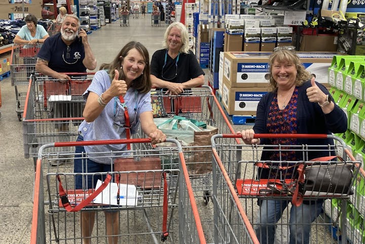 Four volunteers shopping for Tour de Manure