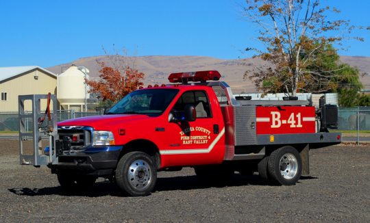 A red fire service brush truck labeled “B-41” parked outside on a clear day.