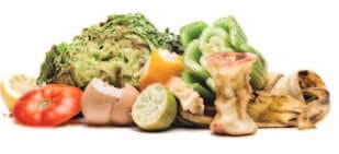 A pile of food waste including vegetable peels, fruit cores, and eggshells.