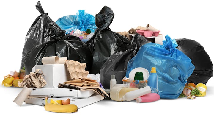 A pile of garbage bags, food waste, discarded paper, and plastic containers.