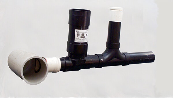 Arrangement of black and white PVC pipes, including a trap and ventilation connections.