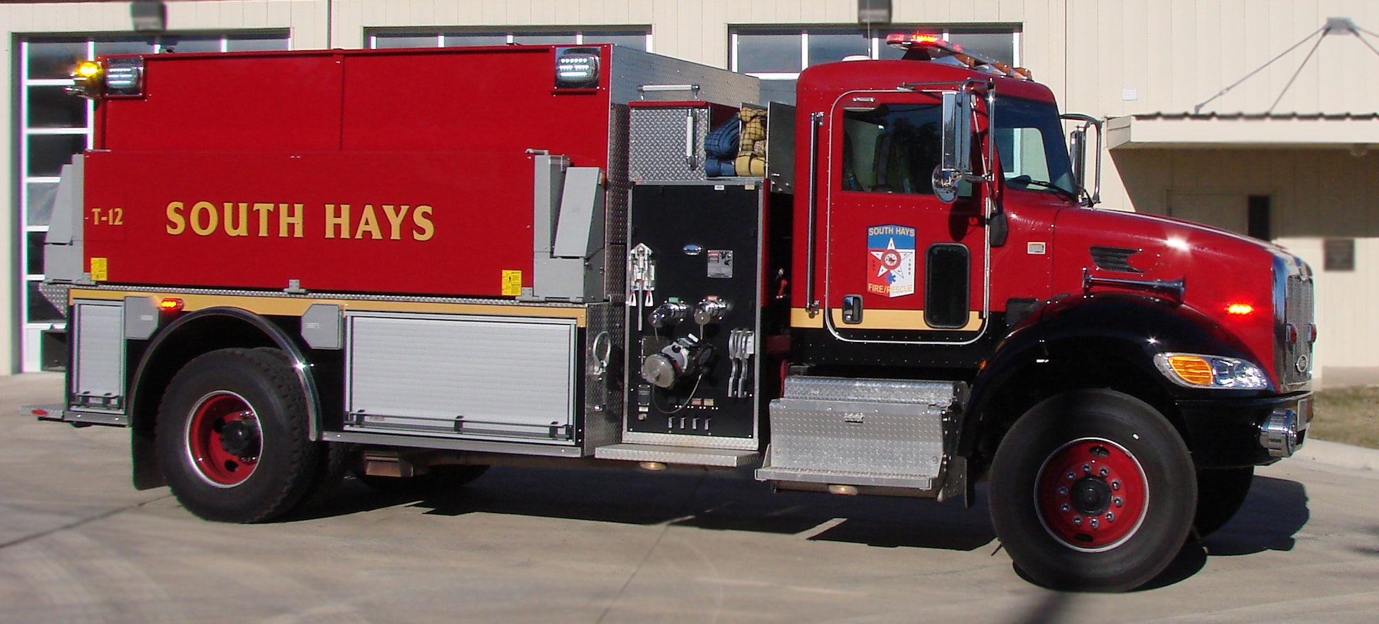 A red fire truck labeled "SOUTH HAYS" with emergency lights and firefighting equipment.
