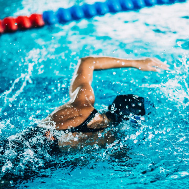 May contain: leisure activities, person, sport, swimming, water, water sports, pool, and swimming pool