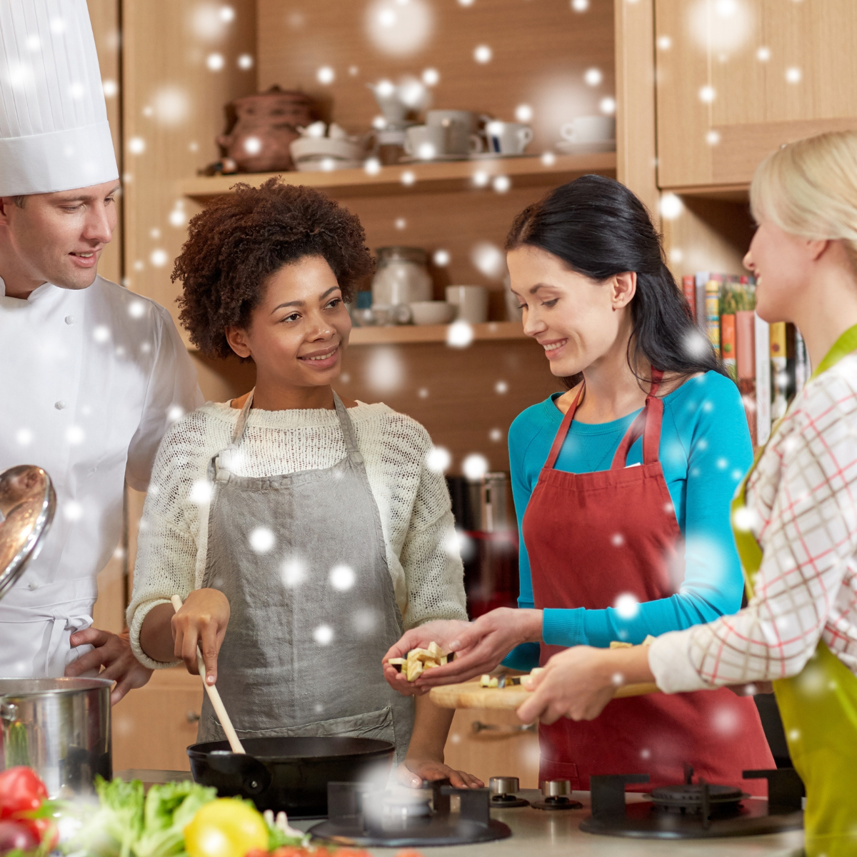 A chef and three people with aprons in a kitchen, cooking and smiling together, enhanced with sparkling lights.