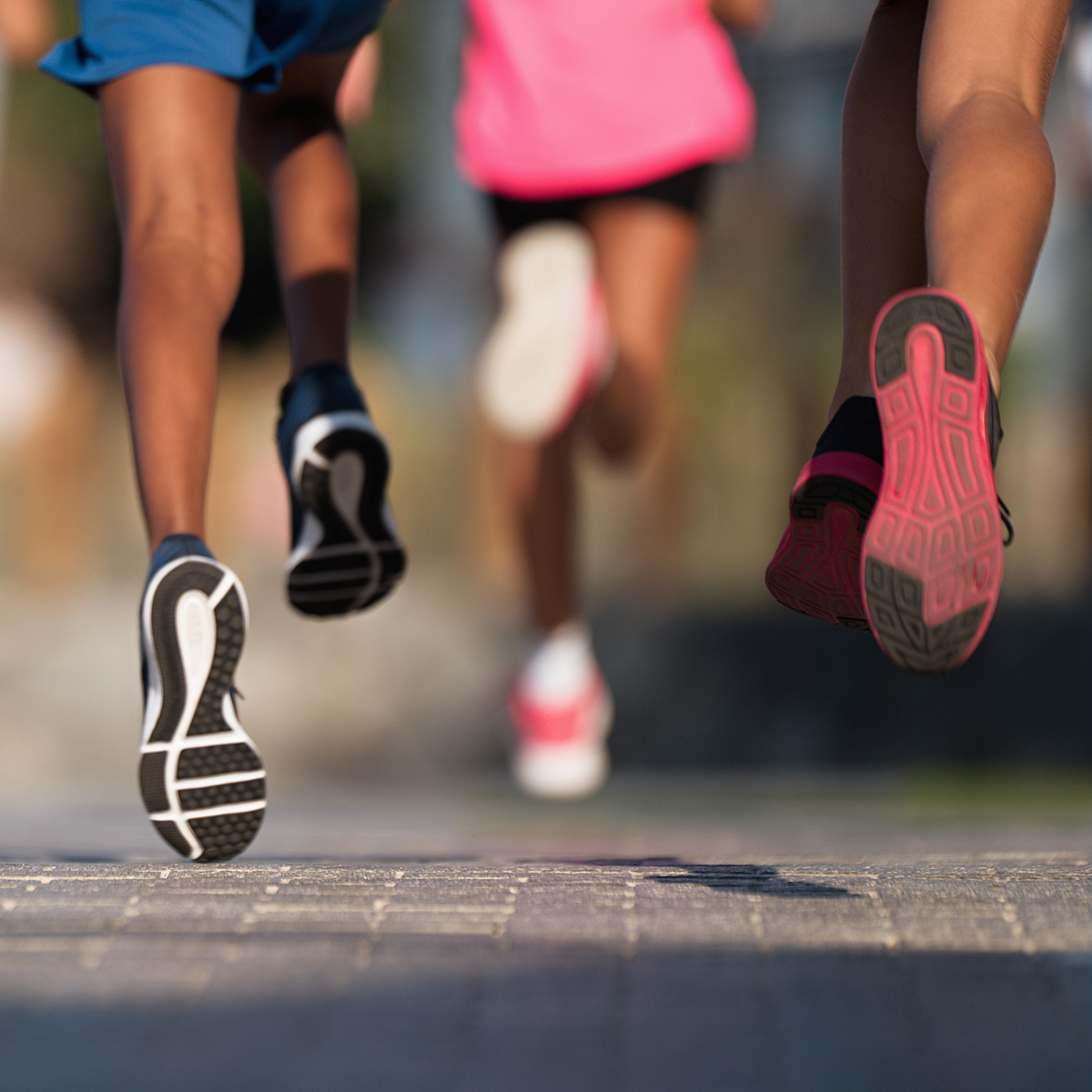 Close-up of runner's shoes in motion on a path.