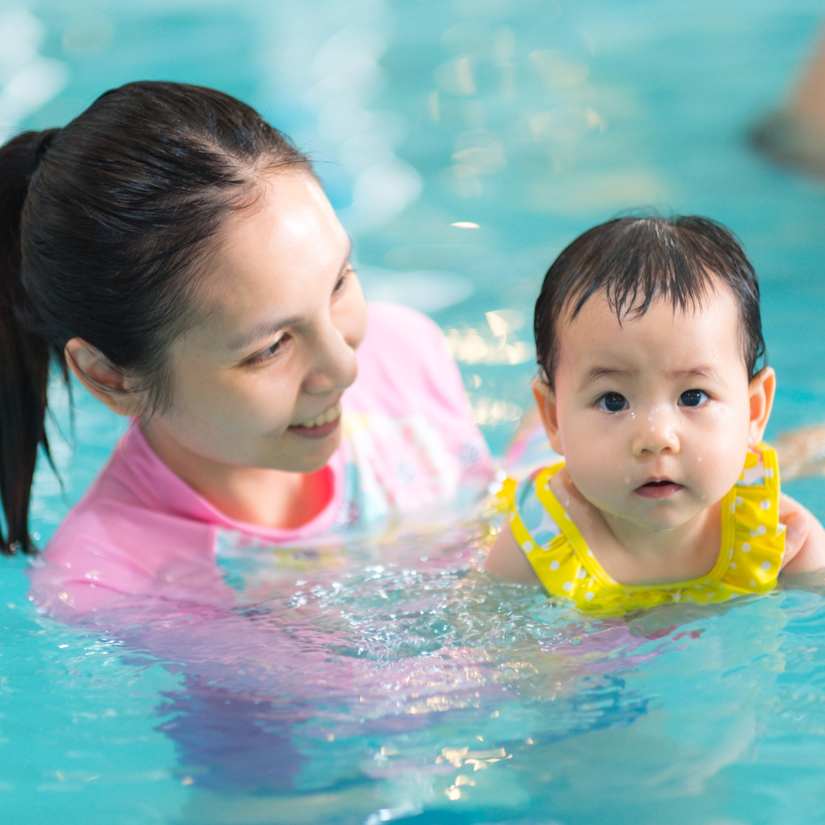 May contain: leisure activities, person, sport, swimming, water, water sports, pool, baby, face, head, photography, portrait, and swimming pool