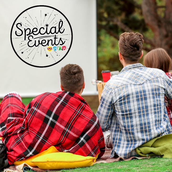 People sitting outside in blankets, watching a screen with "Special Events" text.