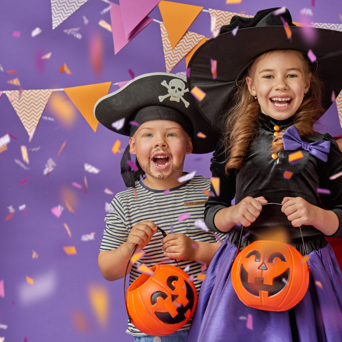Two kids in Halloween costumes, a pirate and a witch, with candy buckets, surrounded by confetti and banners on a purple background.