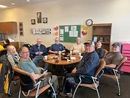 people posing for photo at table