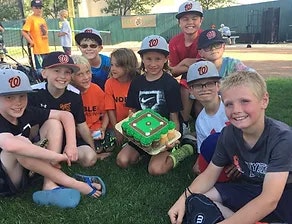 baseball kids sitting on grass